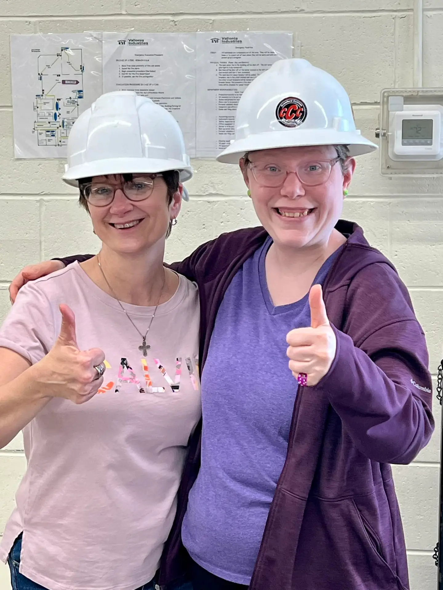 two individuals with thumbs up