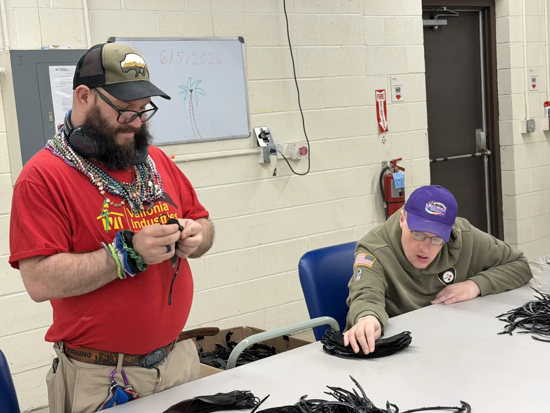 two individuals working on assembly