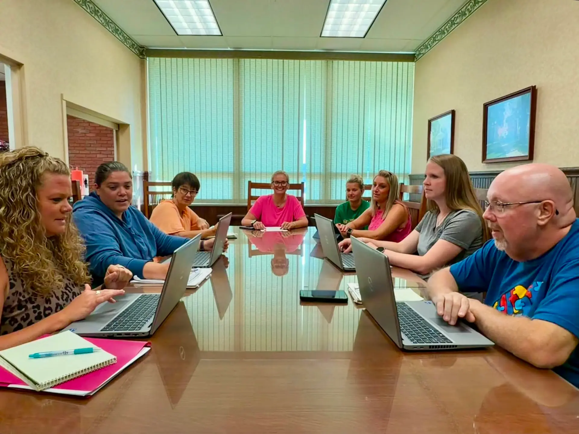 Vallonia Team Meeting room with people at table